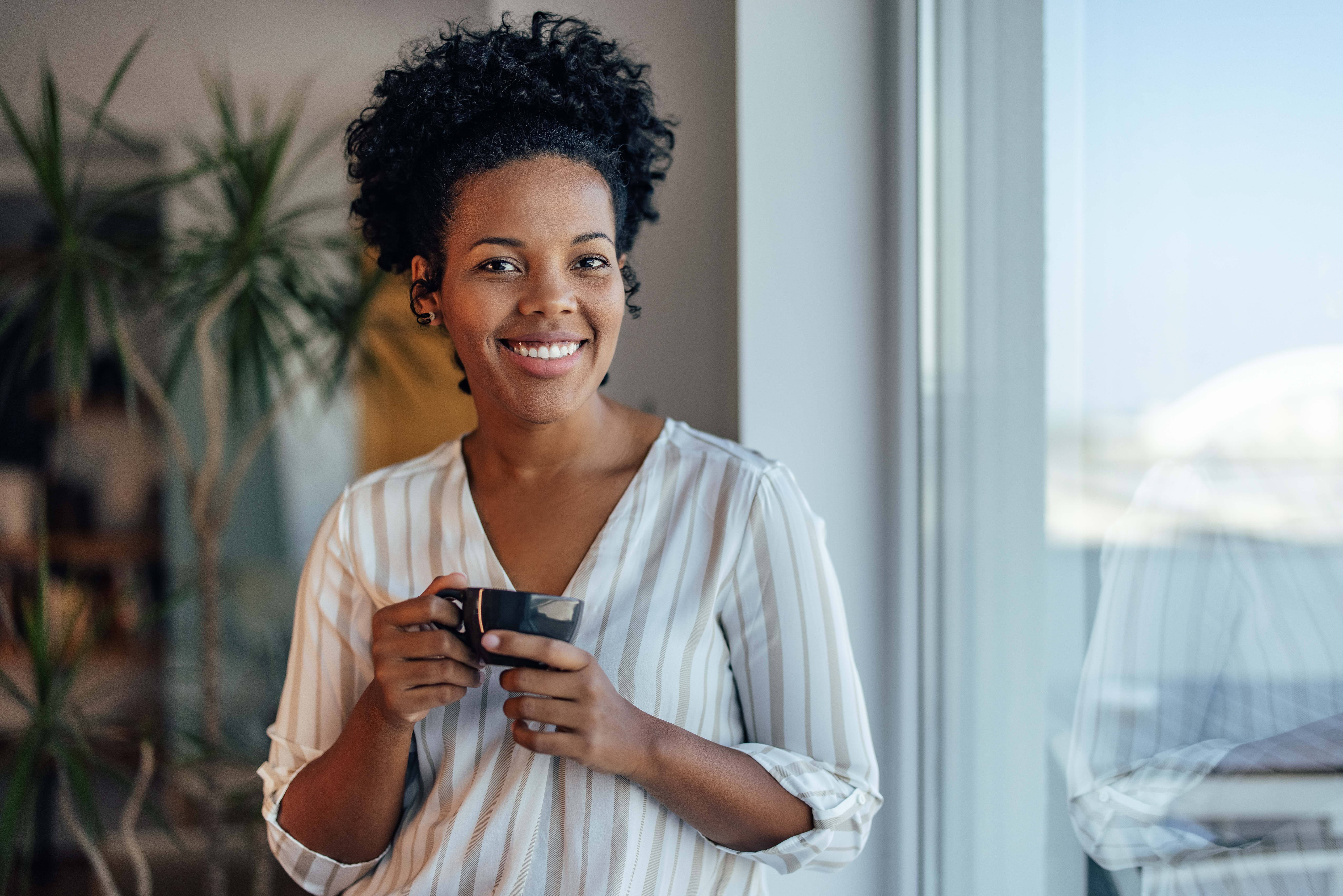 Adult woman, taking a picture inside her house.